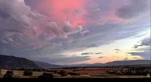 View of mountain backdrop with rural landscape