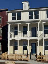 View of front facade with board and batten siding and roof with shingles