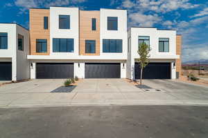 Contemporary home featuring stucco siding, concrete driveway, and a garage