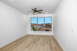 Unfurnished room featuring light wood finished floors and a ceiling fan