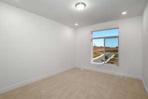 Unfurnished room with light carpet and recessed lighting