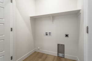 Laundry room featuring light wood-style flooring, washer hookup, and hookup for an electric dryer
