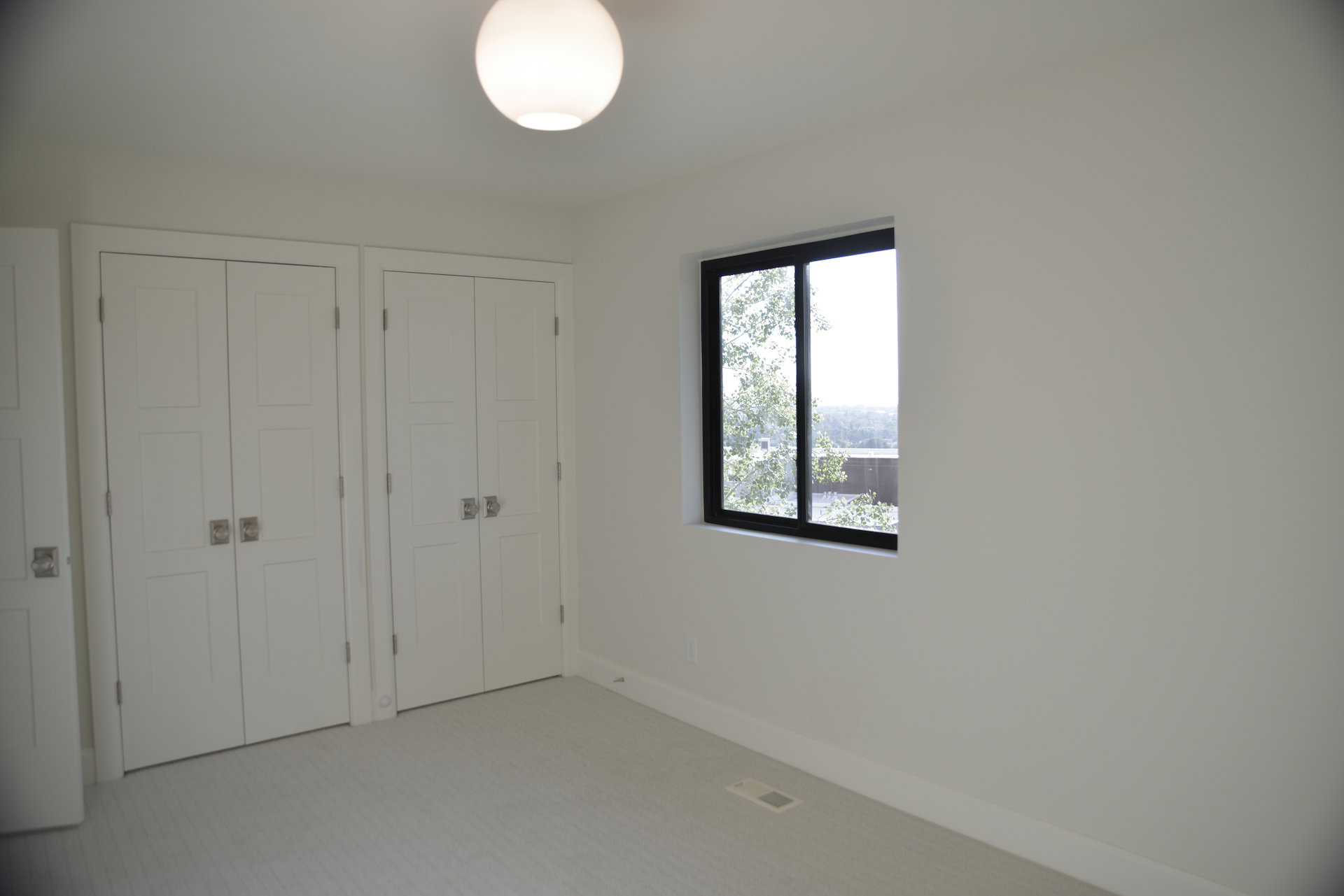 Unfurnished bedroom featuring two closets and carpet