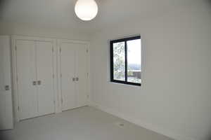 Unfurnished bedroom featuring two closets and carpet