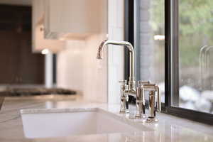 Kitchen view of light stone counters and white cabinetry