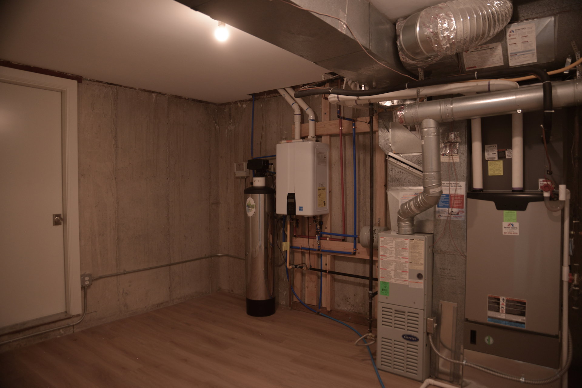 Utility room featuring heating unit and water heater