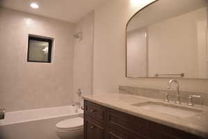 Full bath with shower / bath combination, vanity, and recessed lighting
