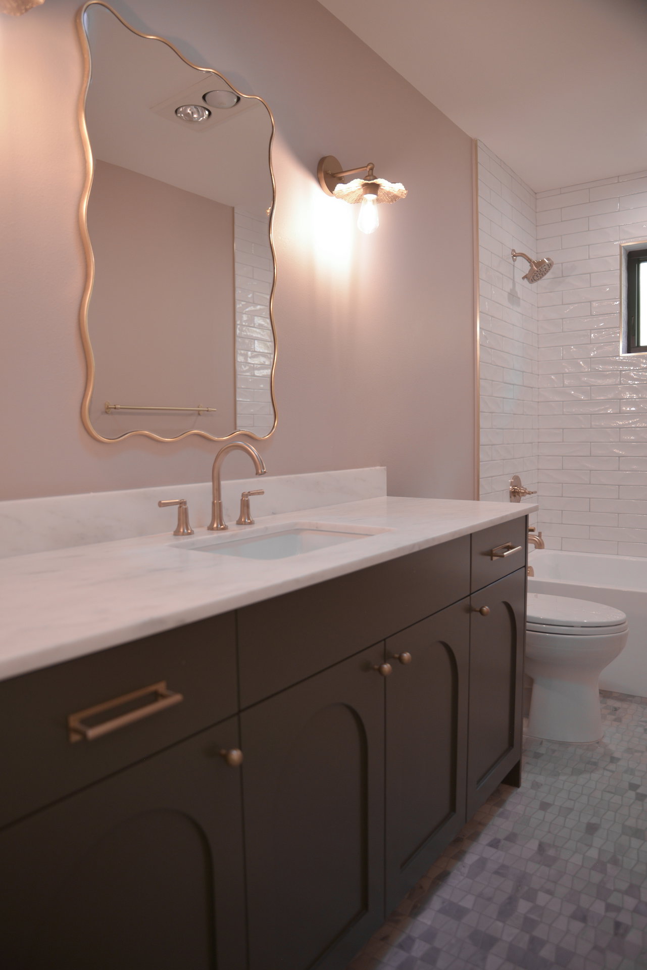 Full bath with vanity, washtub / shower combination, and light tile patterned flooring