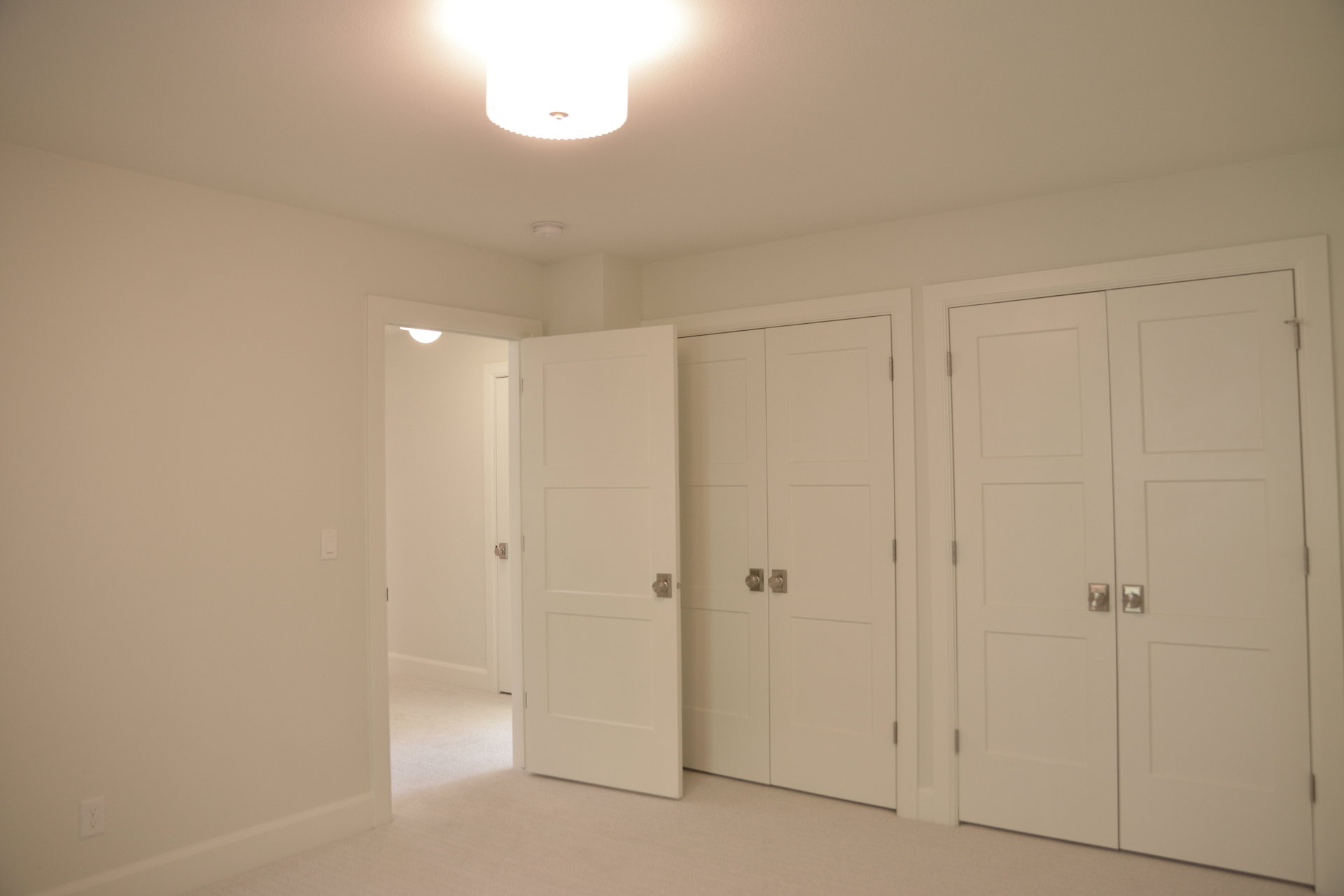 Unfurnished bedroom featuring two closets and carpet floors