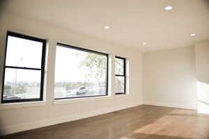 Empty room with recessed lighting and wood finished floors