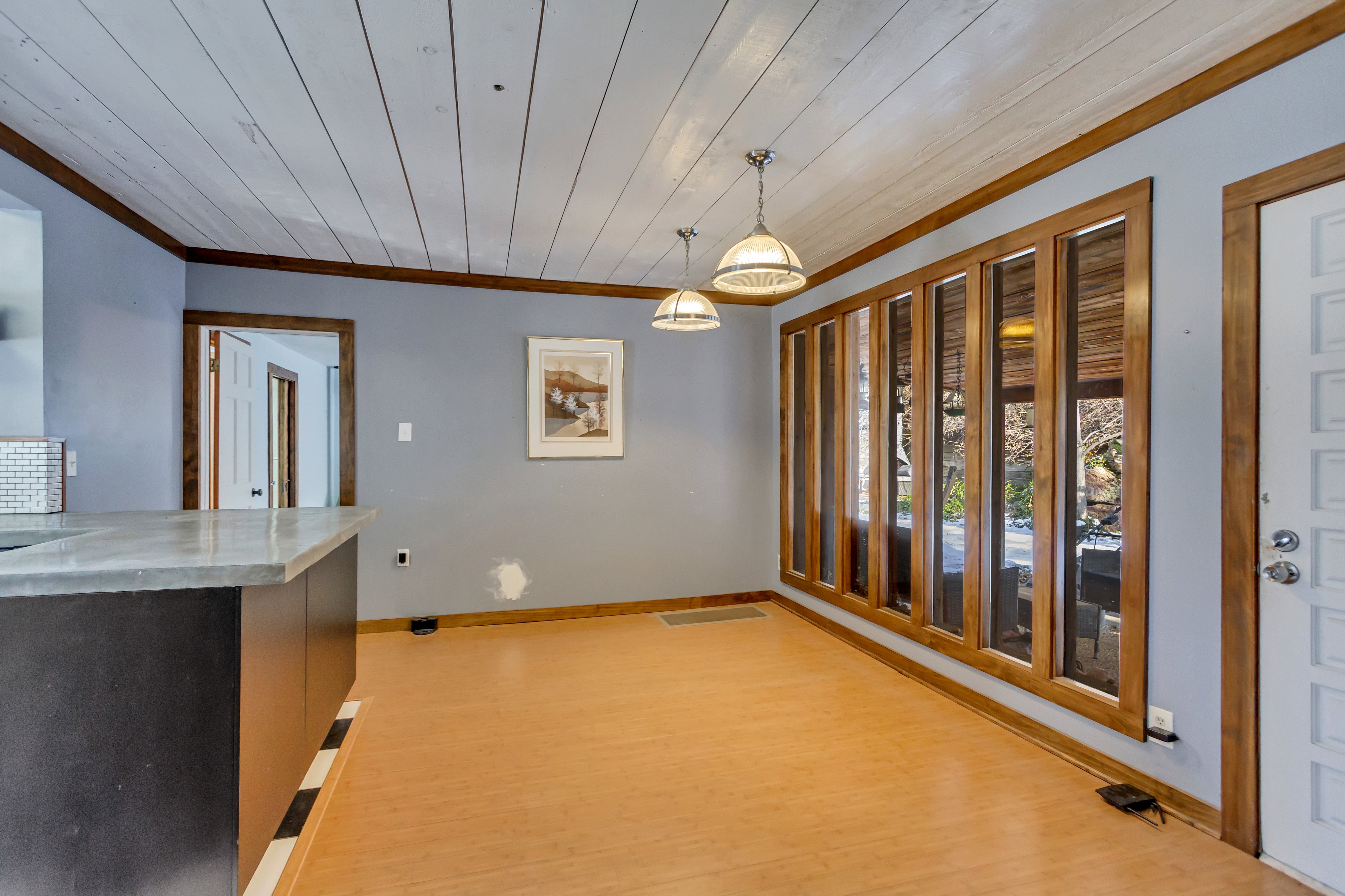 Unfurnished dining area with light wood-type flooring, wood ceiling, and ornamental molding