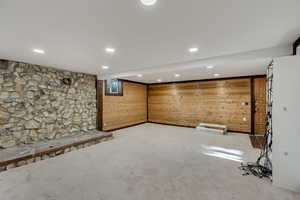 Below grade area with wood walls, carpet, and recessed lighting