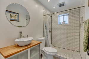 Full bath featuring vanity, a stall shower, and recessed lighting