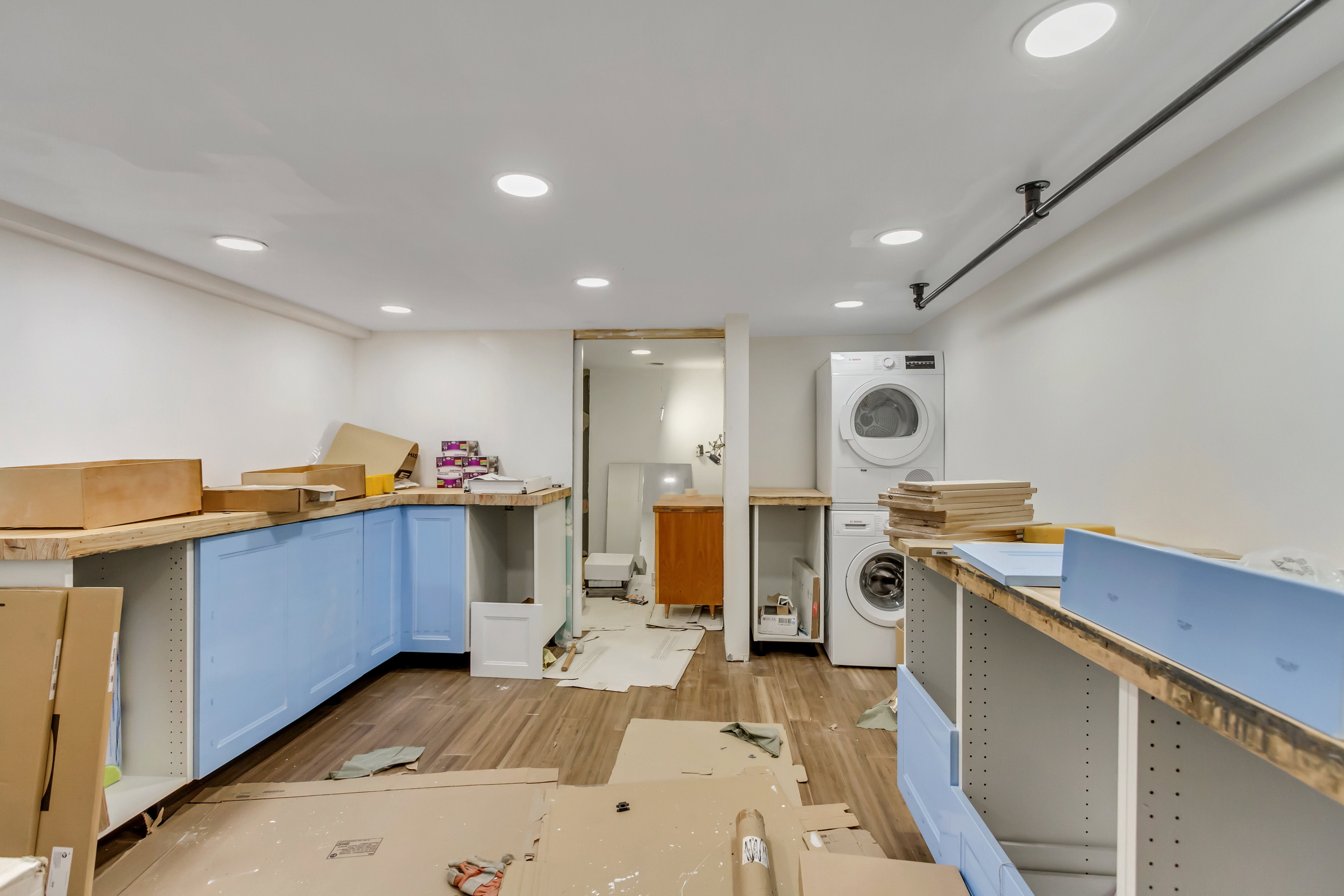 Kitchen featuring estacked washer and dryer, light wood-style floors, and recessed lighting