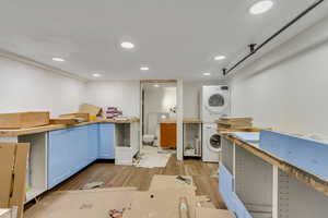 Kitchen featuring estacked washer and dryer, light wood-style floors, and recessed lighting