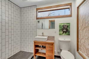 Bathroom with a tile shower and vanity