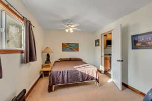 Bedroom featuring light colored carpet and a ceiling fan