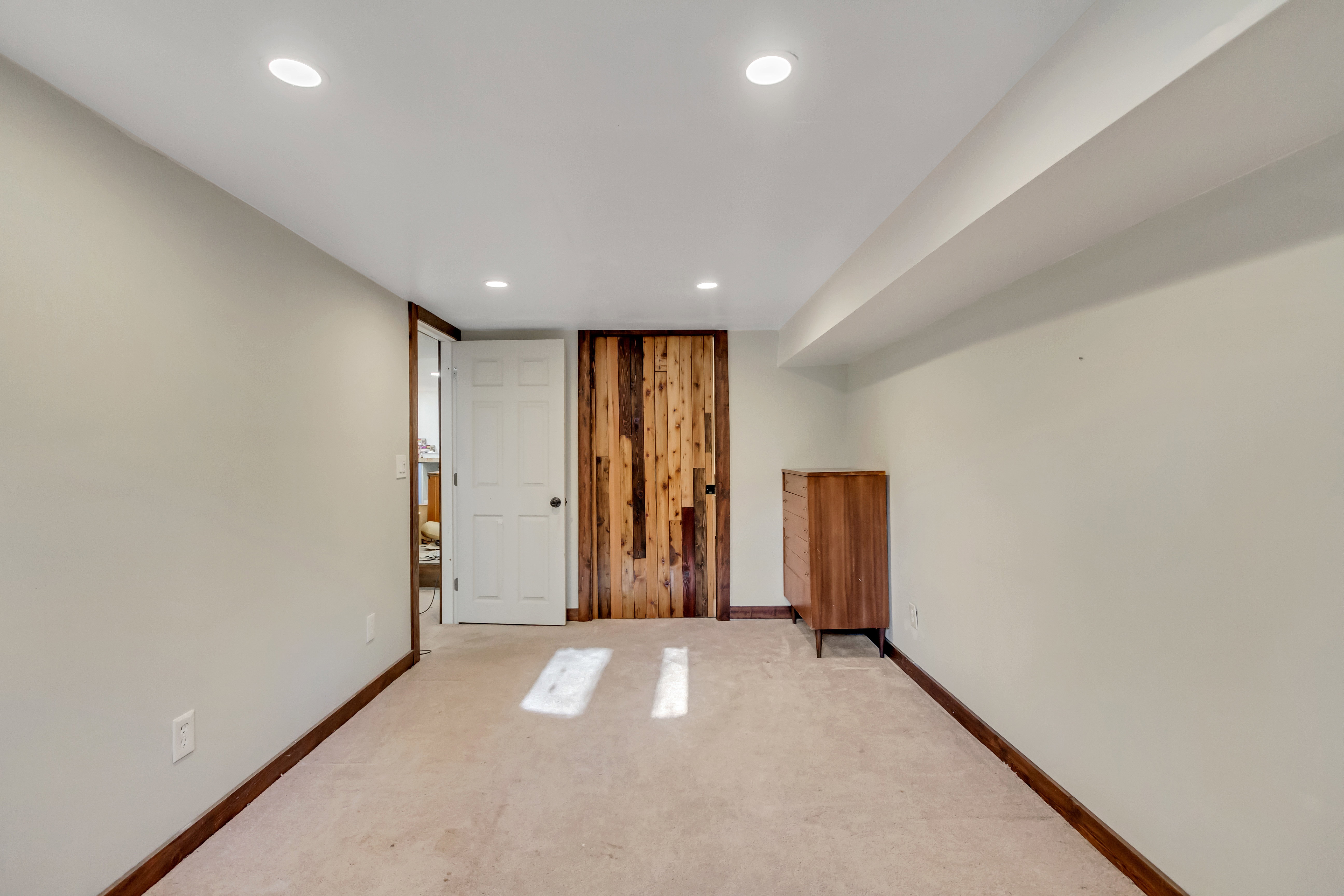 Carpeted empty room with baseboards and recessed lighting