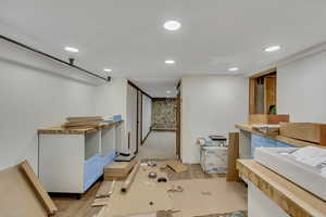 Below grade area with wood finished floors and recessed lighting