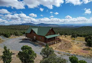 Aerial view of property and surrounding area featuring mountains