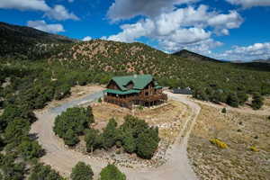Aerial view of property and surrounding area featuring mountains