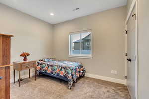Bedroom featuring light carpet and recessed lighting