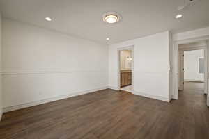 Unfurnished room with dark wood-type flooring and recessed lighting