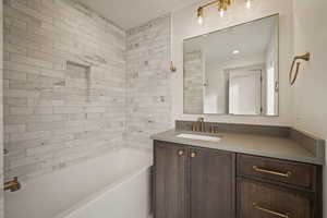 Bathroom with bathing tub / shower combination and vanity