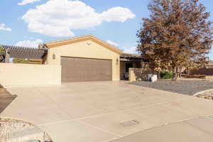 View of front of house featuring stucco siding, concrete driveway, an attached garage, and a tiled roof