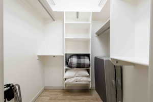 Walk in closet featuring light wood-type flooring