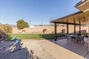 Fenced backyard with a patio and outdoor dining area