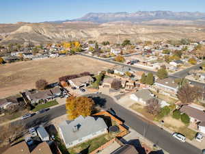 Aerial overview of property's location with nearby suburban area and a mountainous background