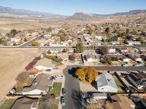 Aerial view of property's location featuring nearby suburban area and mountains