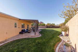 Fenced backyard with a patio area and an outdoor living space