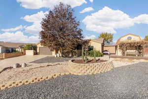 View of front of home featuring driveway, stucco siding, and a garage