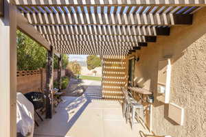 Fenced backyard featuring a pergola, a patio, and outdoor dining area