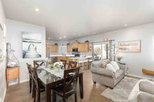 Dining room with light tile patterned flooring and recessed lighting