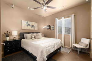 Bedroom featuring tile patterned floors and a ceiling fan