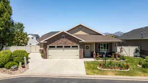 Craftsman house with brick siding, a garage, concrete driveway, and a shingled roof