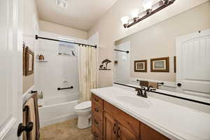 Bathroom with vanity and shower / bathtub combination with curtain