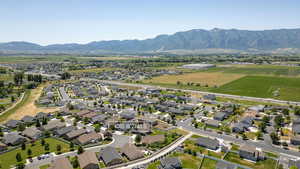 Aerial view of property's location featuring a mountainous background and nearby suburban area