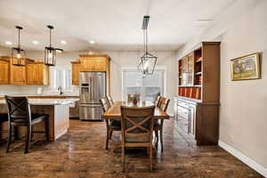 Dining room with dark wood finished floors, a chandelier, and recessed lighting
