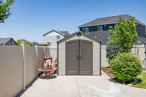 View of shed with a fenced backyard