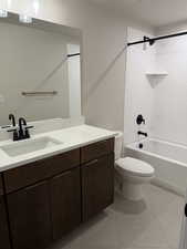 Full bathroom with vanity, shower / bath combination, and light tile patterned floors