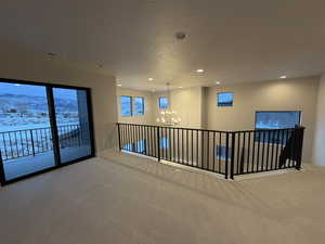 Hallway with carpet, a mountain view, a chandelier, a textured ceiling, and recessed lighting
