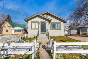 Bungalow featuring a fenced front yard