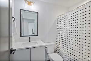 Full bathroom featuring a shower with curtain and vanity