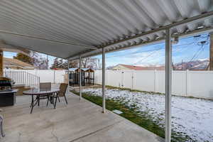 Fenced backyard with a patio area, area for grilling, outdoor dining area, and a shed