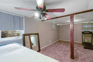 Unfurnished bedroom featuring carpet flooring, ceiling fan, and a textured ceiling