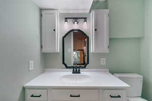 Bathroom with vanity and a textured ceiling